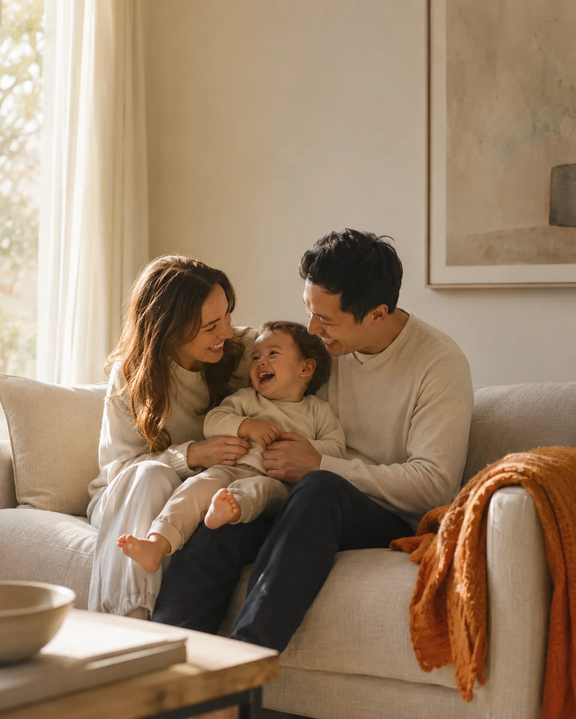 A family together on a sofa in warm light.